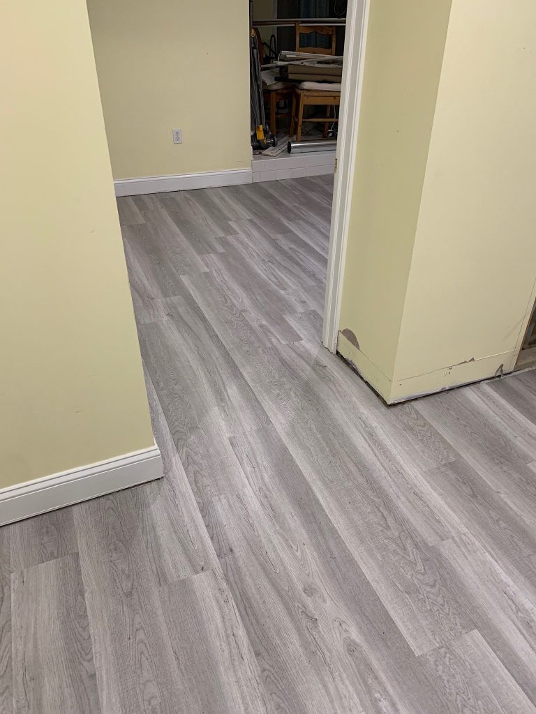 Gray luxury vinyl plank flooring in a hallway